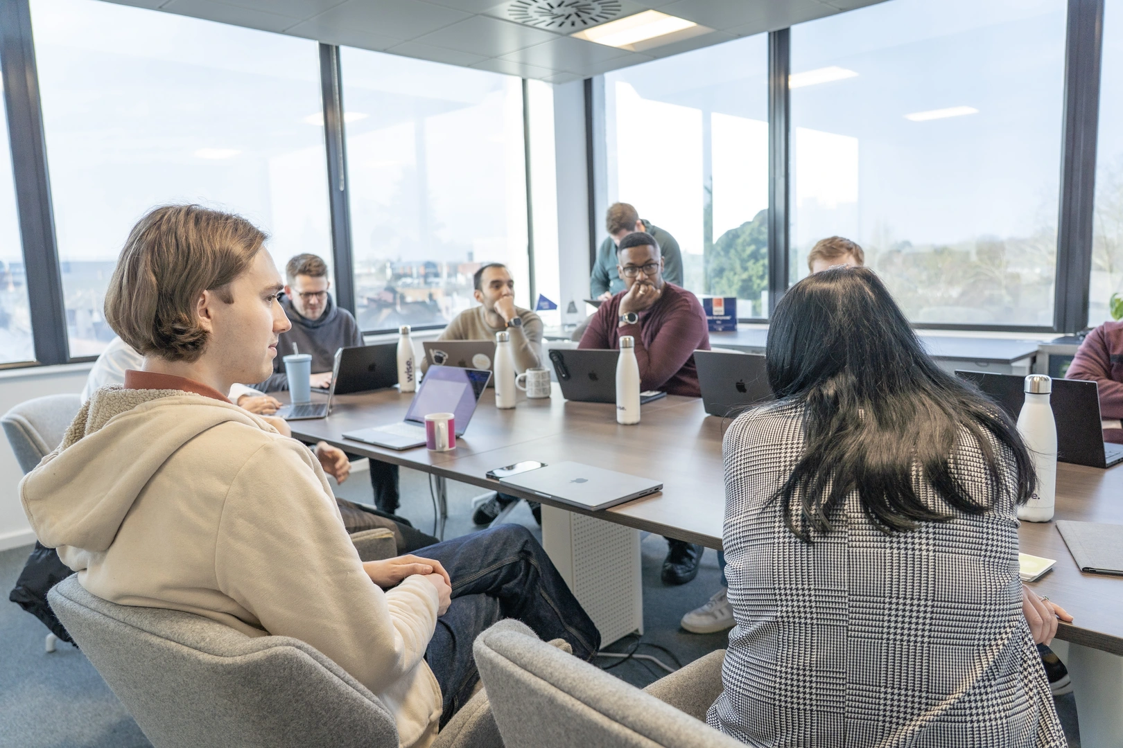 Wise employees gathered around a table at a meeting